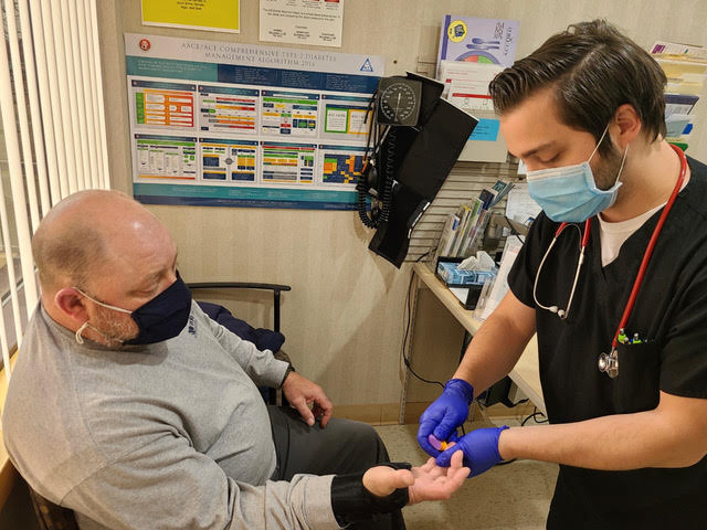 Doctor testing patients blood