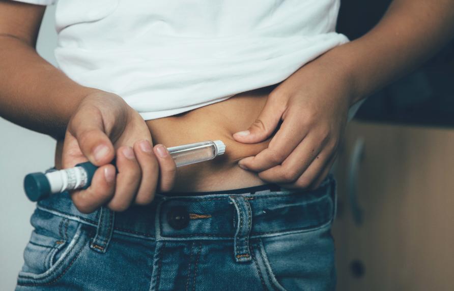 Person injecting insulin in stomach